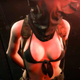 Quiet sits with a bag over her head and her breasts exposed.